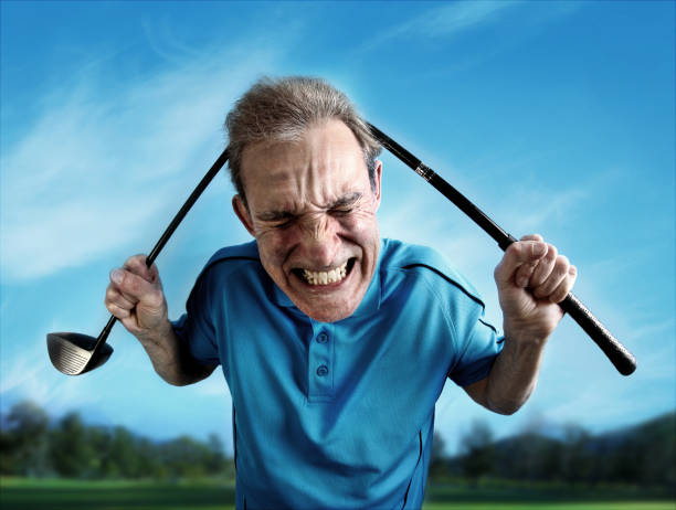 Frustrated golfer An angry, frustrated golfer bends a club over his head. Wide-angle lens distortion adds a humorous, cartoonish appearance to the subject. athlete fails stock pictures, royalty-free photos & images
