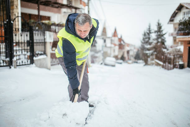 istock Man cleaning doorway after snowfall 932069908