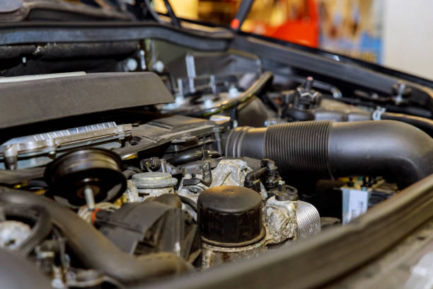 istock Old and dirty car engine in the garage. 932073516