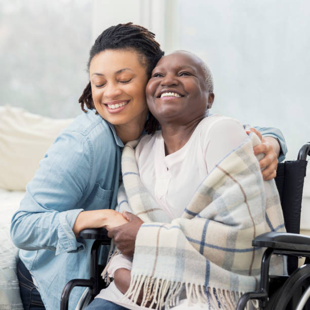 istock Caring daughter hugs wheelchair-bound mother 932074802