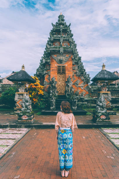 istock Woman walking in Balinese temple 932092944