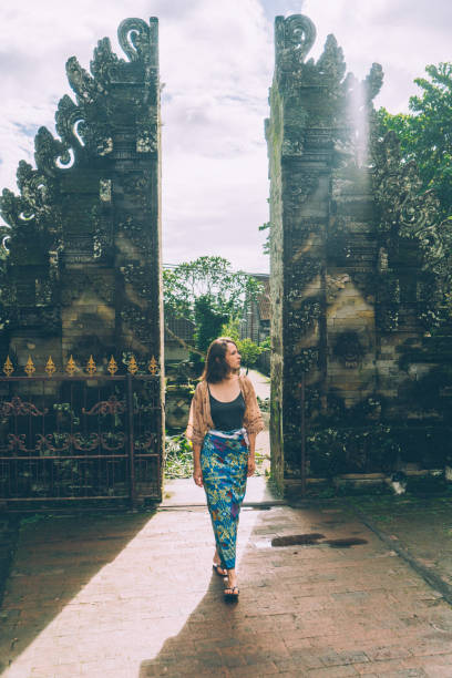 istock Woman walking in Balinese temple 932093388
