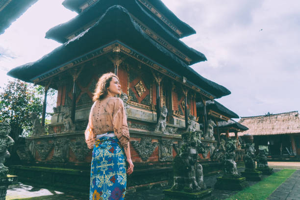 istock Woman walking in Balinese temple 932093390