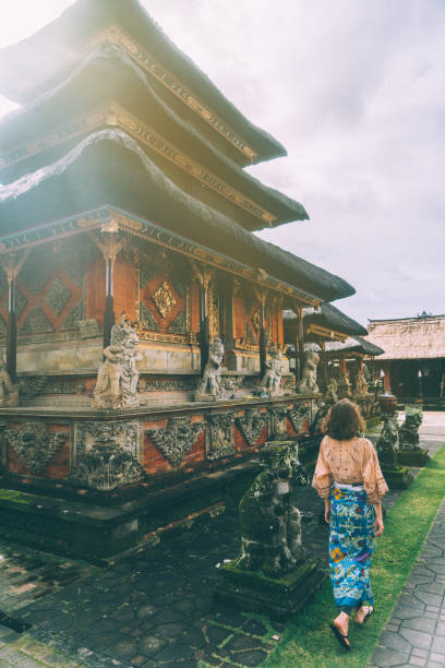 istock Woman walking in Balinese temple 932093400