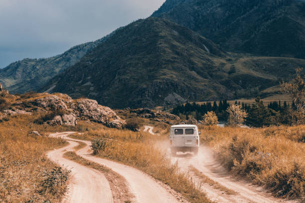 istock The car is moving forward along a dirt road. 932093648