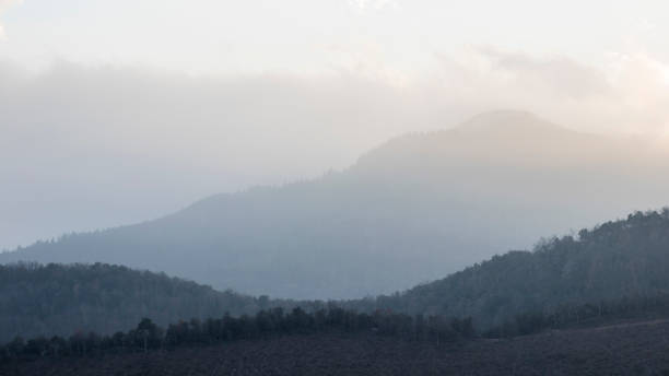 istock Foggy mountain crest landscape on a blue sky sunset 932100120