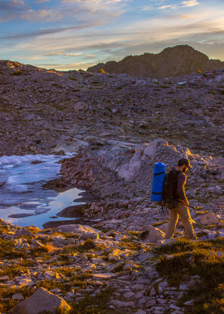 istock Man hiker walks on mountain trail 932100348