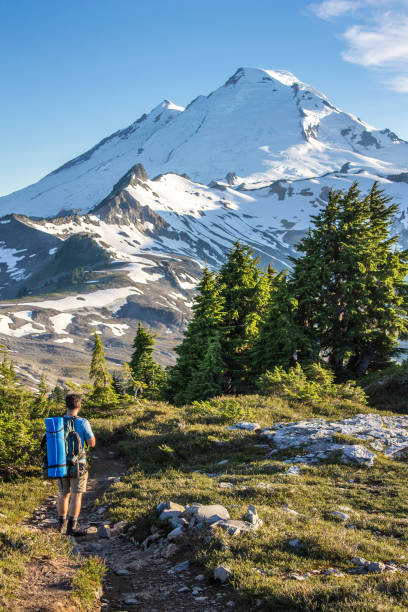 istock Man hiker walks on mountain trail 932100370