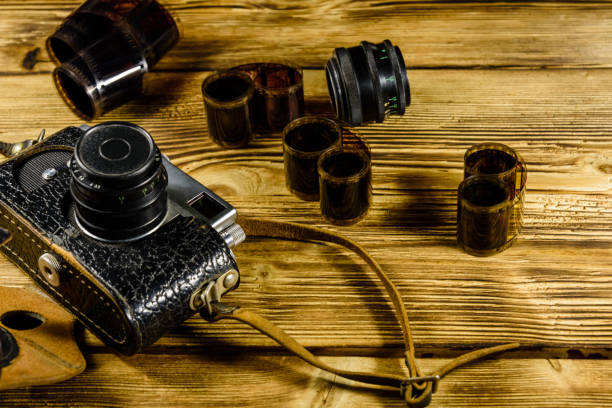 istock Old rangefinder camera and films on wooden table 932101030