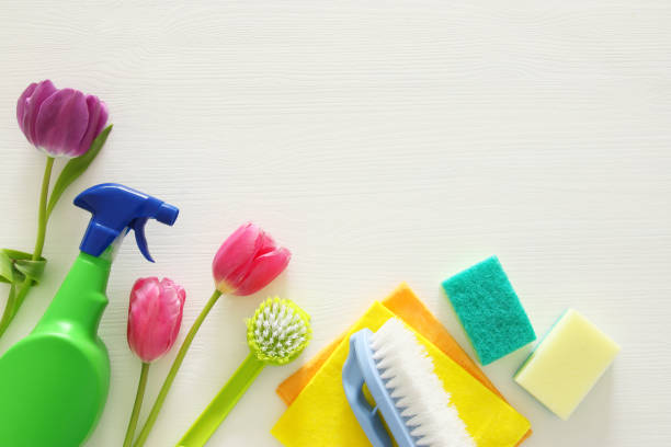 istock Spring cleaning concept with supplies on wooden table. 932101164