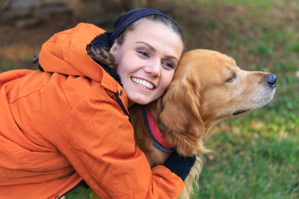 istock Smiling young woman embracing a dog 932107244