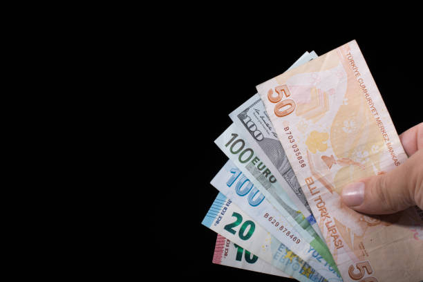 istock Hand holding American dollar  isolated on black background 932107924