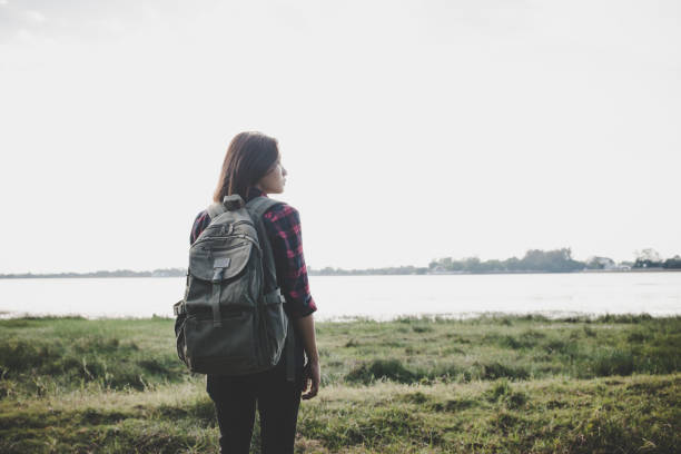 istock Hiker woman with backpack standing enjoy with nature. 932108928