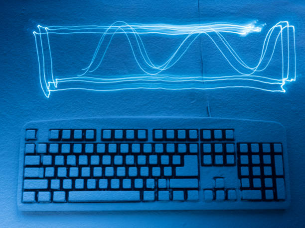 istock computer keyboard covered with snow illuminated by blue light with traces from drawing by light painting 932111350