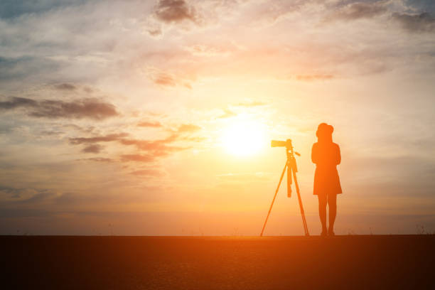 Silhouette of a photographer shoots a sunset.