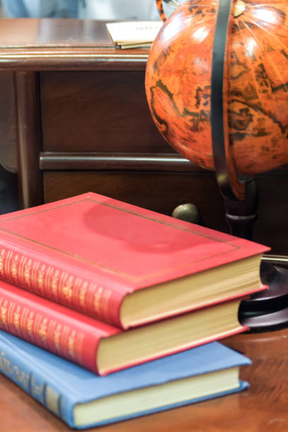 istock old vintage books and globe on table. 932111896