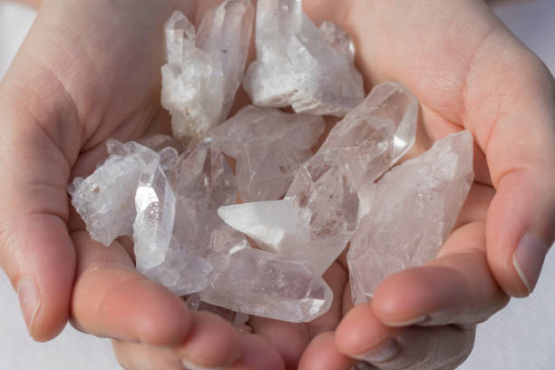 istock Several pieces of beautiful quartz crystal in hands 932111920
