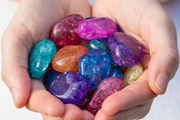 istock Several pieces of beautiful crackled quartz crystal in hands 932111924