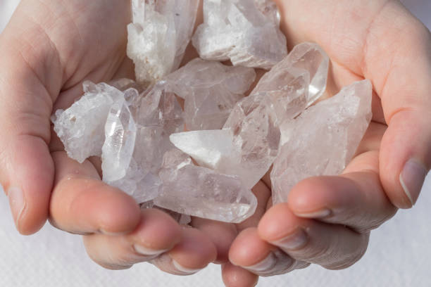 istock Several pieces of beautiful quartz crystal in hands 932111954