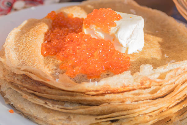 istock russian pancakes with red caviar and butter, closeup 932116802