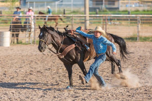 istock Goat Tying Young Women at a Dusty Rodeo 932117506