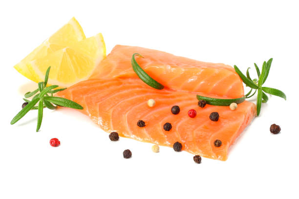 istock Red fish. Raw salmon fillet with rosemary isolate on white background 932121294