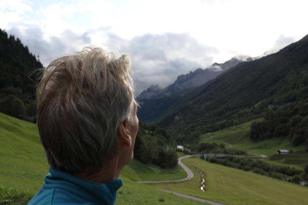 istock Man looks to mountains 932125572