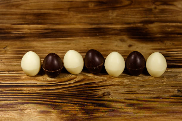 istock Small chocolate candies on wooden table 932125618