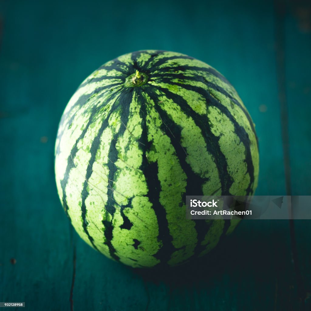 Watermelon On the dark wood in door low light Close-up Stock Photo