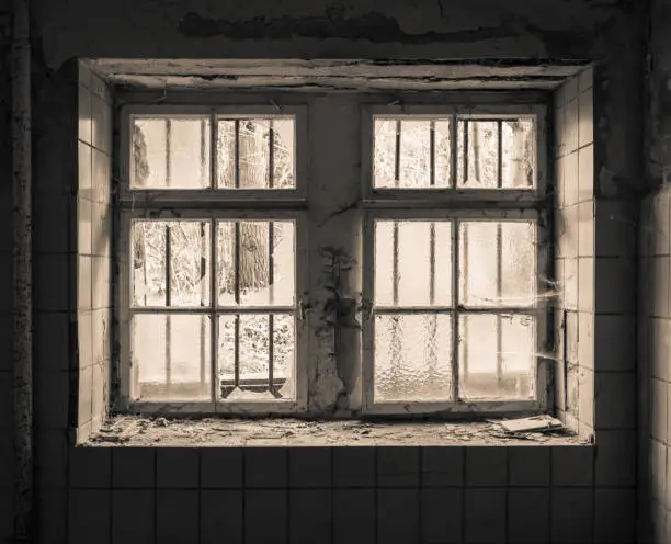 an old dilapidated window with a grid
