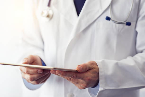 istock Male doctor working on a digital tablet 932134082