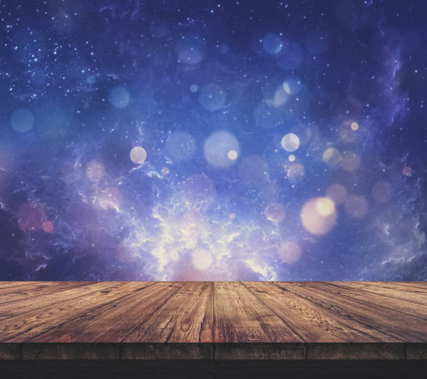istock Wood table top with blurred light colourful bokeh abstract background 932134084