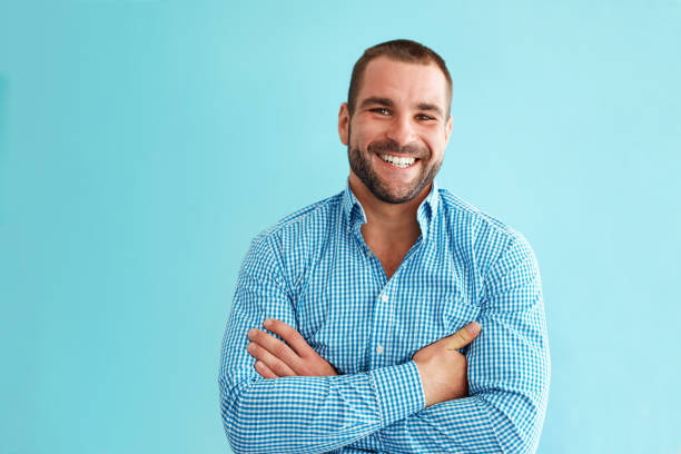 istock Man standing in front of turquoise wall 932134136