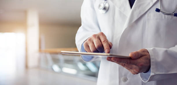 istock Male doctor presses on screen digital tablet 932135810