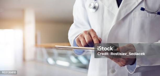 Male Doctor Presses On Screen Digital Tablet Stock Photo - Download Image Now - Doctor, Healthcare And Medicine, Digital Tablet