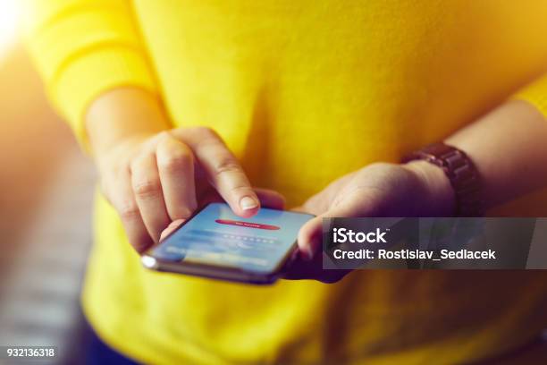 Woman Signs Up To Banking With Her Mobile Phone Stock Photo - Download Image Now - Holding, Smart Phone, Telephone