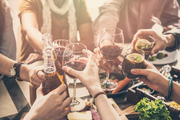 istock Group of people having meal togetherness dining toasting glasses 932137752