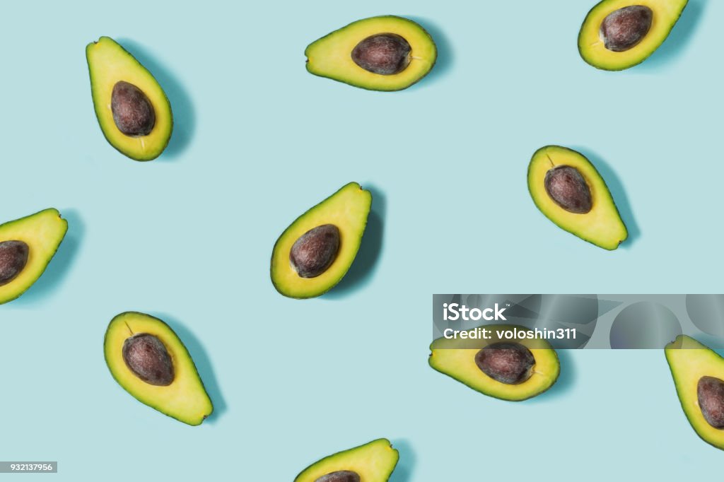 Avocado on the blue background. Top view Avocado on the blue background. Pattern. Top view Avocado Stock Photo
