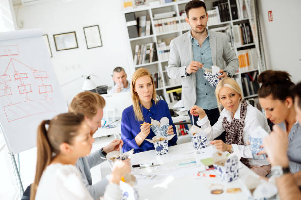 istock Business people eating in office 932140690