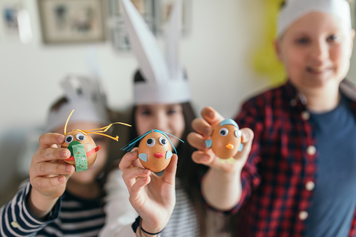 Photo of kids having fun decorating Easter eggs