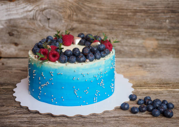 istock home pale blue cake with blueberries and raspberries 932149792
