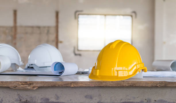 istock The safety helmet and the blueprint on table at construction site 932153082