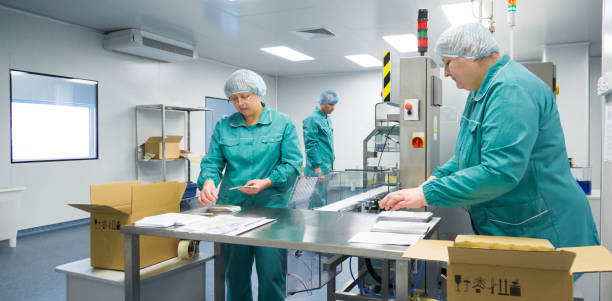 istock Pharmaceutical factory workers in sterile environment 932154442