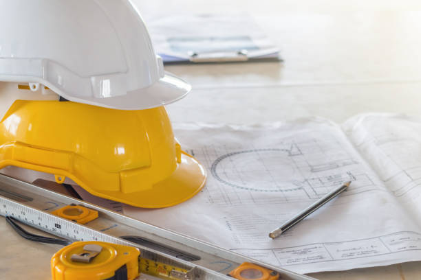 istock The safety helmet and the blueprint on table at construction site 932154822