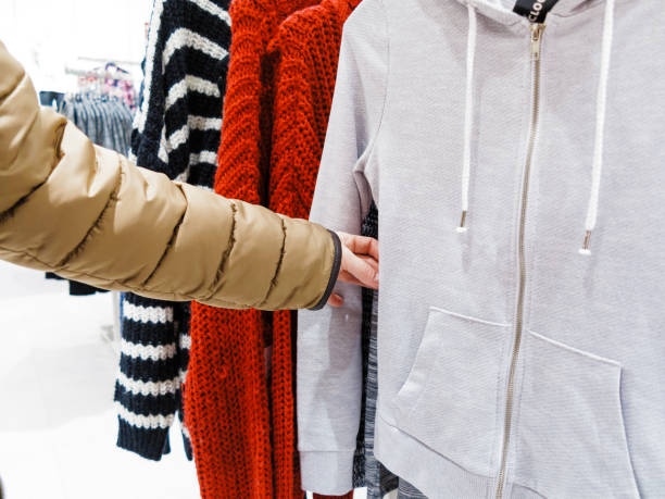 istock Buyer watching clothes in shop. 932160606