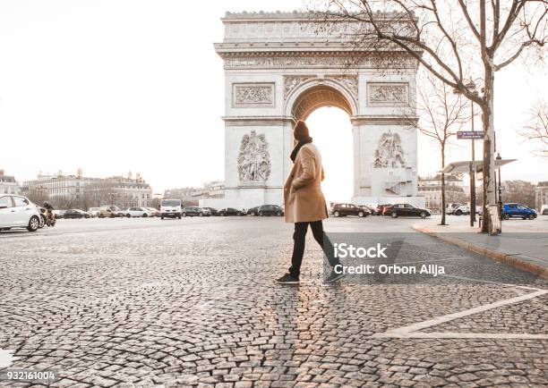 Man Walking In Front Of Arc De Triomphe Stock Photo - Download Image Now - Winter, Walking, Street