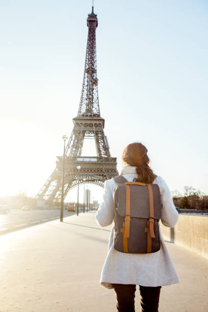 istock Woman walking to the Eiffel tower 932161034