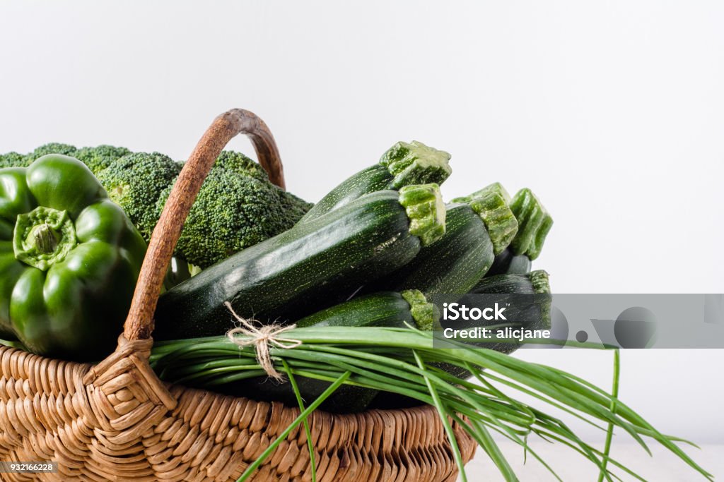 Green vegetables in the basket, farm fresh vegetable from local farmer market, assorted produce isolated on white background Basket Stock Photo