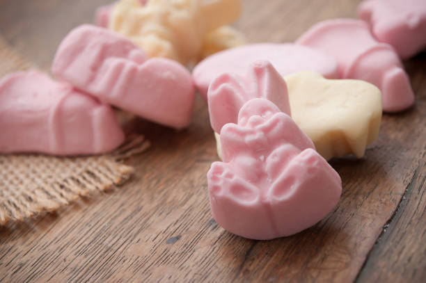 istock easter candies in shaped bell and rabbit on wooden table background 932168746
