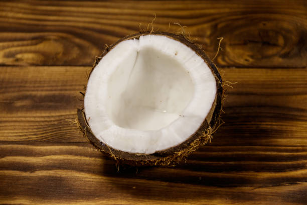 istock Fresh ripe coconut on rustic wooden table 932169990